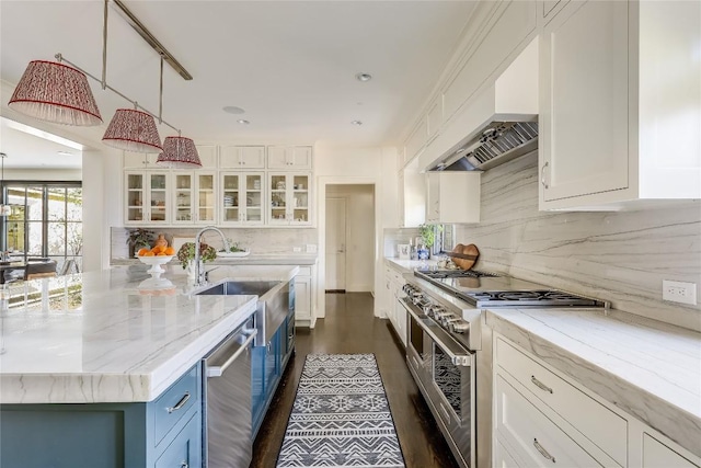 3317 Bowman Ave, Austin, TX 78703 - kitchen with appliances with stainless steel finishes, blue cabinetry, white cabinets, a sink, and decorative backsplash