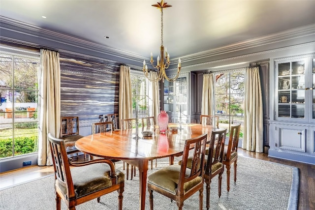 3317 Bowman Ave, Austin, TX 78703 - dining area with a chandelier, ornamental molding, wallpapered walls, and dark wood-style flooring