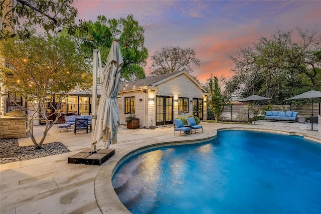 3317 Bowman Ave, Austin, TX 78703 - pool at dusk featuring an outdoor hangout area, a patio, an exterior structure, an outbuilding, and french doors