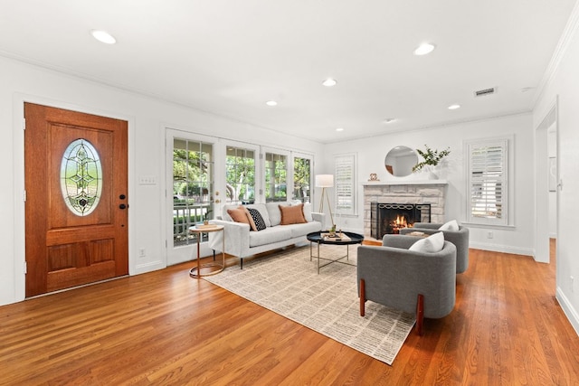 5401 Shoal Creek Blvd, Austin, TX 78756 - living room with crown molding, light wood finished floors, a stone fireplace, recessed lighting, and baseboards