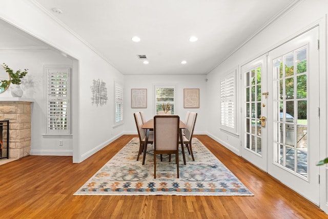 5401 Shoal Creek Blvd, Austin, TX 78756 - dining space with ornamental molding, wood finished floors, baseboards, recessed lighting, and a stone fireplace
