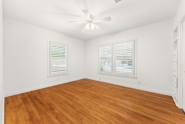 5401 Shoal Creek Blvd, Austin, TX 78756 - unfurnished bedroom with wood finished floors, baseboards, and a ceiling fan