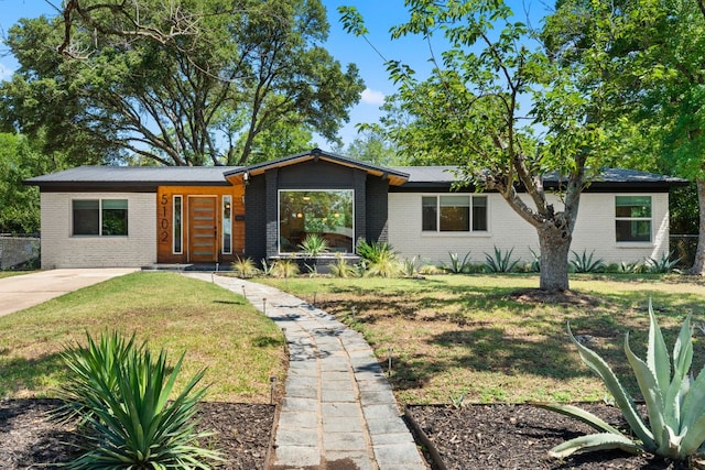5102 Ravensdale Ln, Austin, TX 78723 - mid-century inspired home featuring brick siding and a front lawn