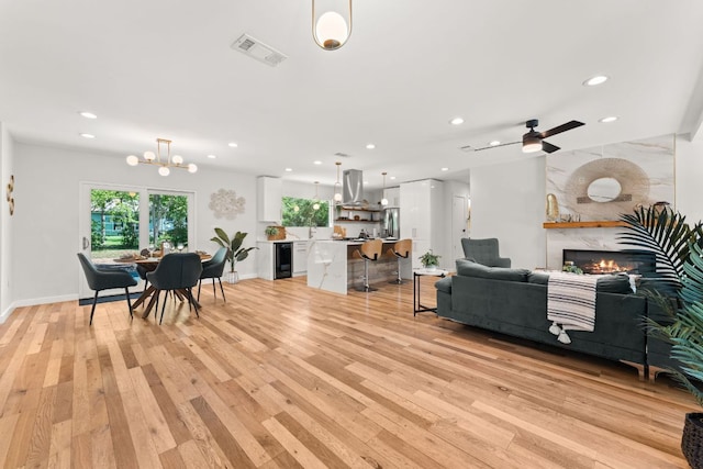 5102 Ravensdale Ln, Austin, TX 78723 - living room featuring light wood finished floors, plenty of natural light, recessed lighting, and a premium fireplace