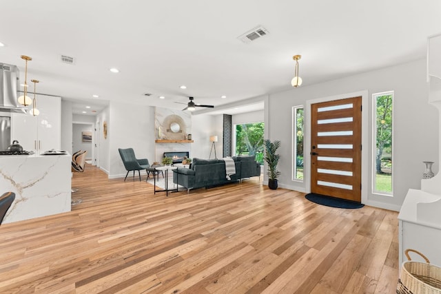 5102 Ravensdale Ln, Austin, TX 78723 - foyer entrance with light wood-type flooring, recessed lighting, a fireplace, baseboards, and a ceiling fan