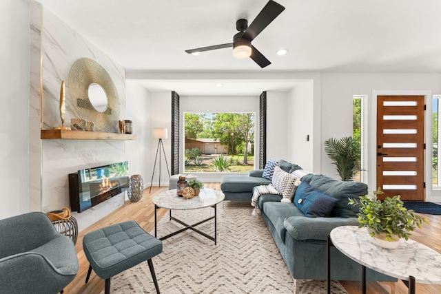 5102 Ravensdale Ln, Austin, TX 78723 - living room featuring wood finished floors, ceiling fan, a premium fireplace, recessed lighting, and baseboards