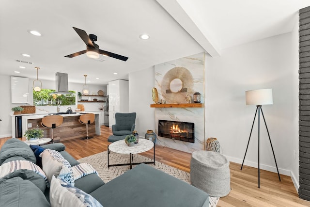 5102 Ravensdale Ln, Austin, TX 78723 - living area with a premium fireplace, light wood finished floors, a ceiling fan, recessed lighting, and baseboards