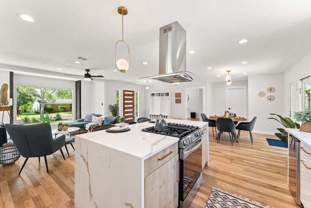 5102 Ravensdale Ln, Austin, TX 78723 - kitchen featuring stainless steel gas range, island exhaust hood, light wood-style floors, recessed lighting, and open floor plan