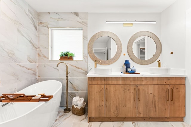 5102 Ravensdale Ln, Austin, TX 78723 - bathroom with marble finish floors, a freestanding tub, double vanity, and tile walls