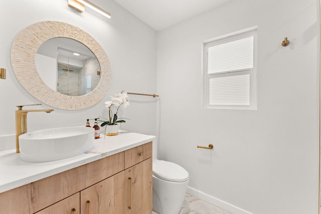 5102 Ravensdale Ln, Austin, TX 78723 - full bath featuring marble finish flooring, vanity, toilet, and baseboards