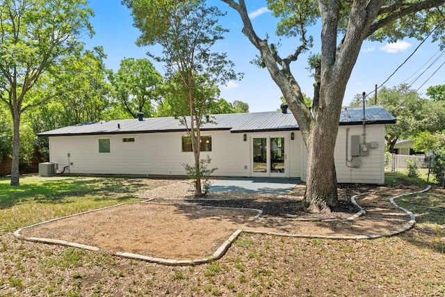 5102 Ravensdale Ln, Austin, TX 78723 - rear view of house with central AC, a patio area, and metal roof