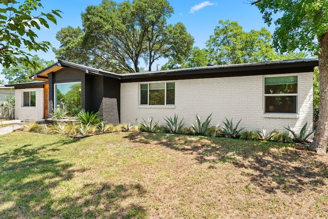 5102 Ravensdale Ln, Austin, TX 78723 - mid-century modern home with brick siding and a front lawn
