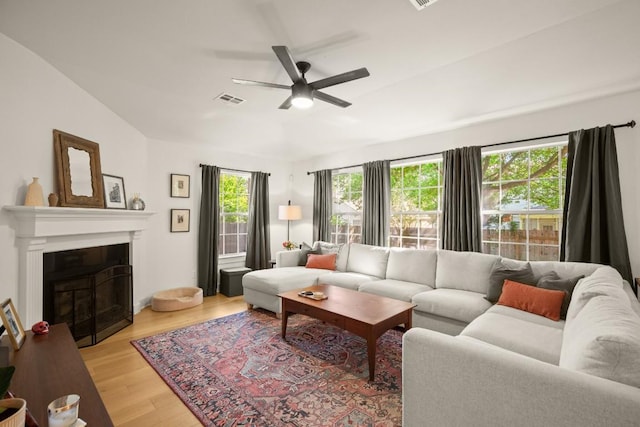 3400 Lynnbrook Dr, Austin, TX 78748 - living area featuring ceiling fan, light wood finished floors, a glass covered fireplace, and lofted ceiling