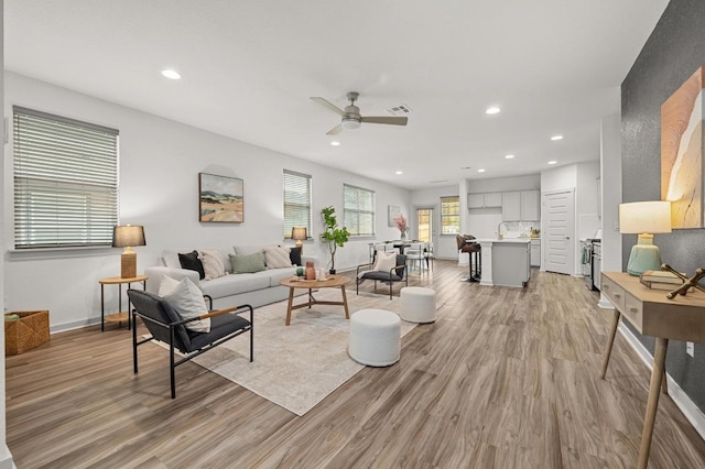 7809 Linnie Ln, Austin, TX 78724 - living room with light wood finished floors, ceiling fan, and recessed lighting