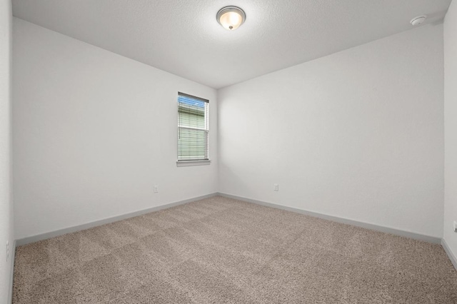 7809 Linnie Ln, Austin, TX 78724 - spare room with light carpet, a smoke detector, and a textured ceiling