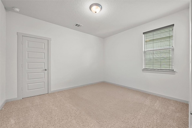 7809 Linnie Ln, Austin, TX 78724 - empty room featuring carpet flooring, a textured ceiling, and a smoke detector