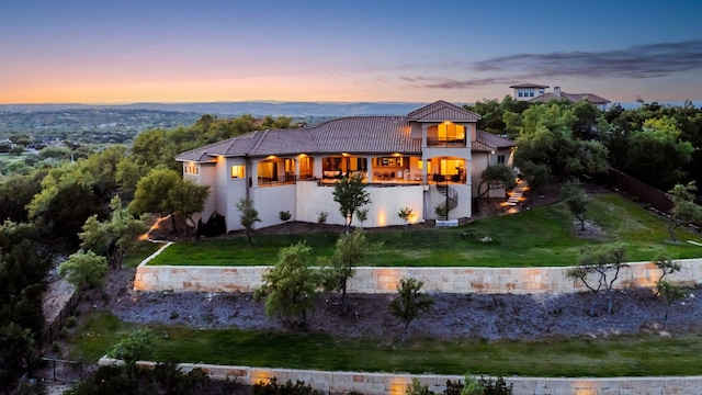 111 Piazza Vetta Dr, Austin, TX 78734 - view of front of home with a tiled roof, stucco siding, a balcony, and a lawn