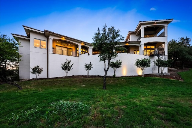 111 Piazza Vetta Dr, Austin, TX 78734 - rear view of property with a balcony, stucco siding, and a lawn