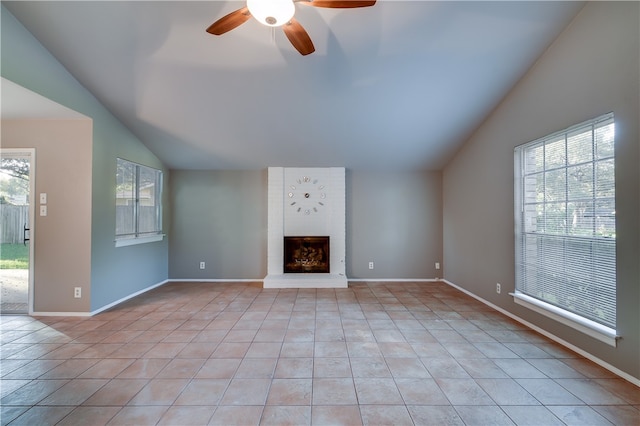 4303 Tamarack Trl, Austin, TX 78727 - unfurnished living room with vaulted ceiling, ceiling fan, light tile patterned flooring, a brick fireplace, and baseboards