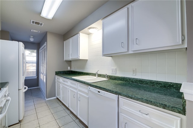4303 Tamarack Trl, Austin, TX 78727 - kitchen featuring white appliances, a sink, light tile patterned floors, white cabinetry, and dark countertops
