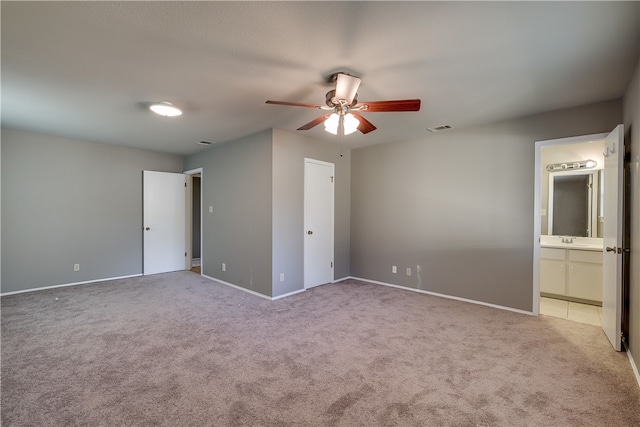 4303 Tamarack Trl, Austin, TX 78727 - unfurnished bedroom with carpet floors, baseboards, a sink, connected bathroom, and ceiling fan