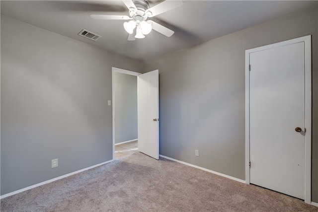 4303 Tamarack Trl, Austin, TX 78727 - unfurnished bedroom with light carpet, baseboards, and a ceiling fan