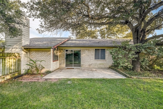 4303 Tamarack Trl, Austin, TX 78727 - rear view of property featuring a patio, brick siding, a shingled roof, and a chimney
