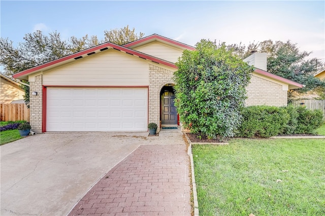 4303 Tamarack Trl, Austin, TX 78727 - view of front of house with brick siding, driveway, an attached garage, and a chimney