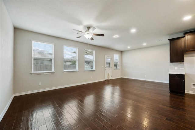 120 Flexus Ln, Liberty Hill, TX 78642 - unfurnished living room featuring ceiling fan, baseboards, dark wood finished floors, and recessed lighting
