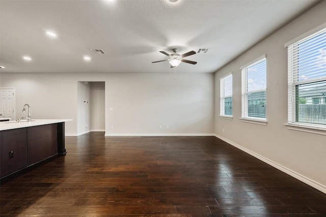 120 Flexus Ln, Liberty Hill, TX 78642 - unfurnished living room with a sink, a ceiling fan, dark wood finished floors, baseboards, and recessed lighting