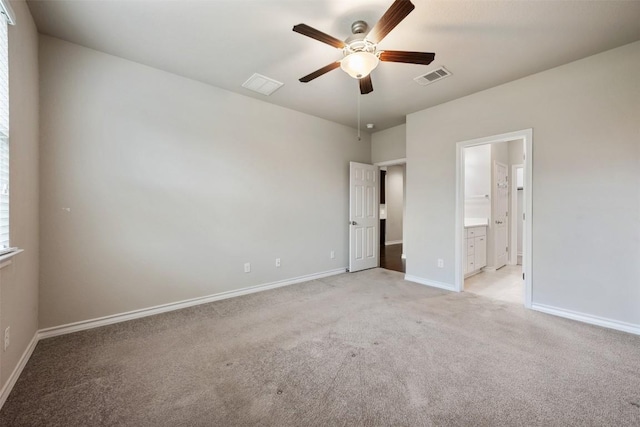 120 Flexus Ln, Liberty Hill, TX 78642 - unfurnished bedroom featuring light carpet, baseboards, connected bathroom, and ceiling fan