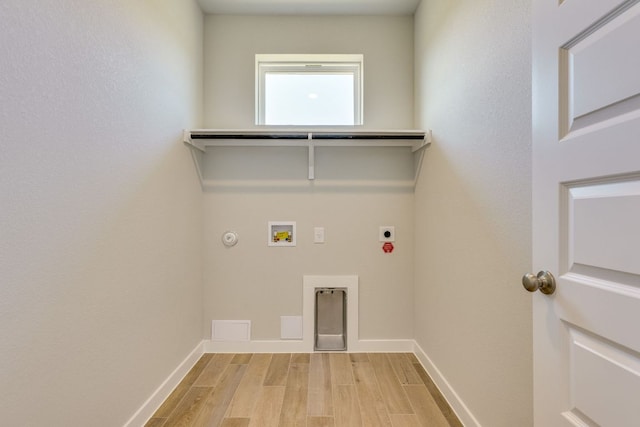 110 Denali Dr, Kyle, TX 78640 - laundry area with electric dryer hookup, washer hookup, gas dryer hookup, light wood-type flooring, and baseboards
