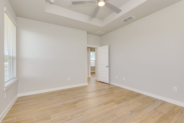110 Denali Dr, Kyle, TX 78640 - empty room featuring a raised ceiling, light wood-type flooring, ceiling fan, and baseboards