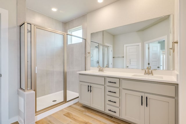110 Denali Dr, Kyle, TX 78640 - bathroom featuring a stall shower, double vanity, wood finished floors, and recessed lighting