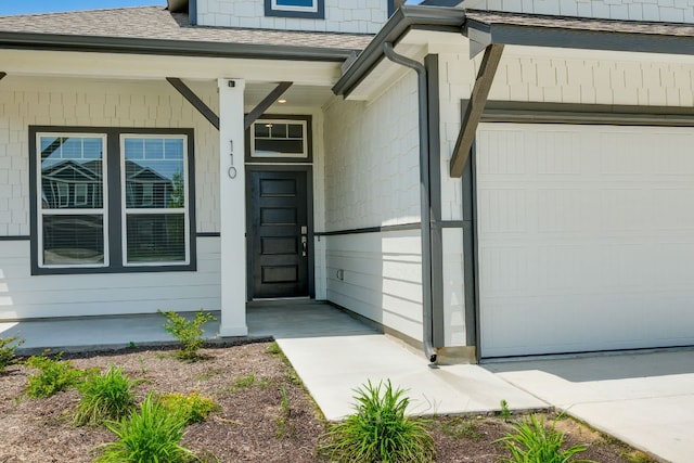110 Denali Dr, Kyle, TX 78640 - entrance to property featuring a shingled roof, a garage, and covered porch
