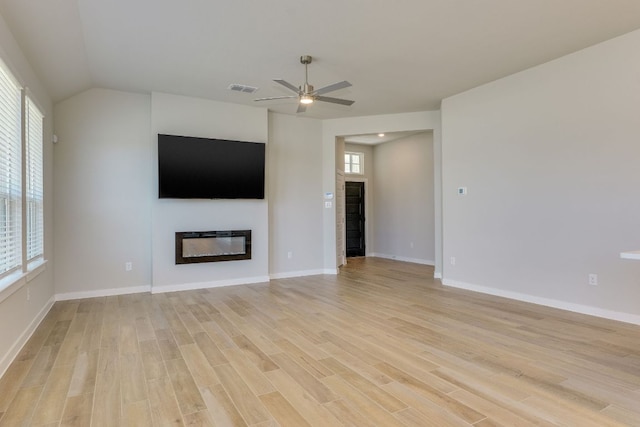 110 Denali Dr, Kyle, TX 78640 - unfurnished living room with a glass covered fireplace, ceiling fan, light wood-style flooring, and baseboards