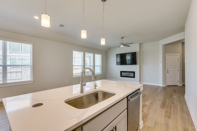 110 Denali Dr, Kyle, TX 78640 - kitchen featuring a sink, stainless steel dishwasher, hanging light fixtures, light wood-style floors, and a ceiling fan