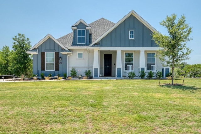 441 Double Eagle Ranch Dr, Cedar Creek, TX 78612 - view of front of property featuring board and batten siding, roof with shingles, a front yard, and covered porch