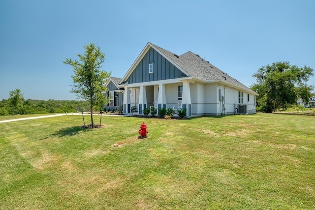 441 Double Eagle Ranch Dr, Cedar Creek, TX 78612 - view of front facade with board and batten siding, central AC, and a front lawn