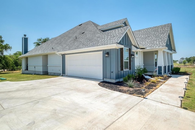 441 Double Eagle Ranch Dr, Cedar Creek, TX 78612 - view of side of property featuring a shingled roof, an attached garage, board and batten siding, driveway, and a yard