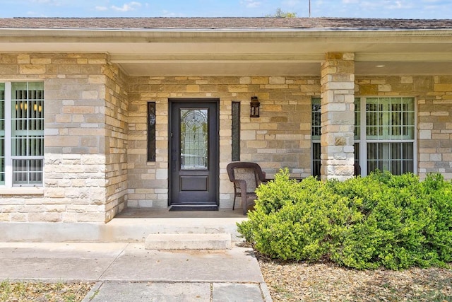 297 Carpers Trl, Fischer, TX 78623 - doorway to property with stone siding, covered porch, and roof with shingles