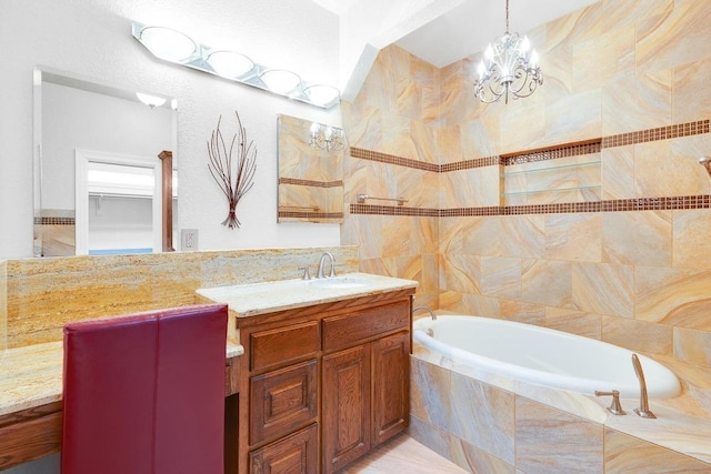 297 Carpers Trl, Fischer, TX 78623 - full bathroom featuring vanity, a bath, a chandelier, and tile walls