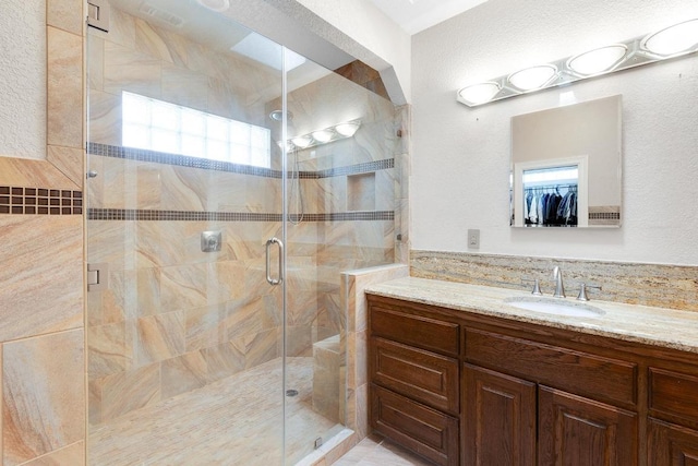 297 Carpers Trl, Fischer, TX 78623 - bathroom with vanity, a stall shower, and a walk in closet
