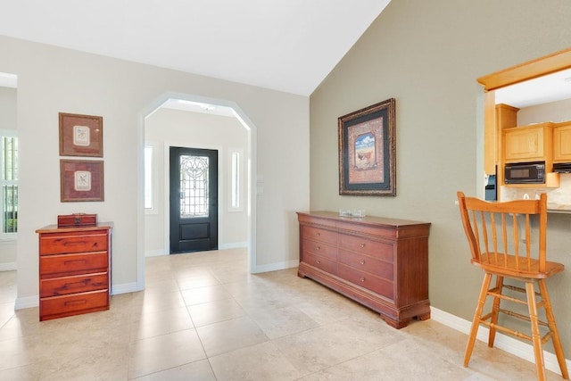 297 Carpers Trl, Fischer, TX 78623 - foyer featuring arched walkways, lofted ceiling, baseboards, and light tile patterned floors