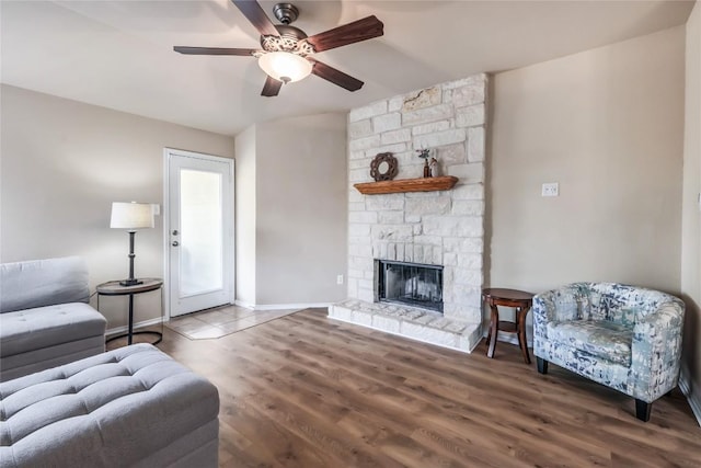 217 Baldwin St, Hutto, TX 78634 - living room featuring a ceiling fan, a fireplace, wood finished floors, and baseboards
