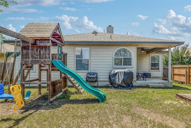 217 Baldwin St, Hutto, TX 78634 - back of house featuring a playground, a patio area, a chimney, and ceiling fan