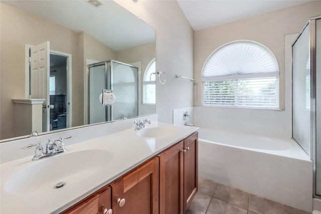 217 Baldwin St, Hutto, TX 78634 - bathroom featuring a bath, tile patterned floors, a shower stall, and double vanity