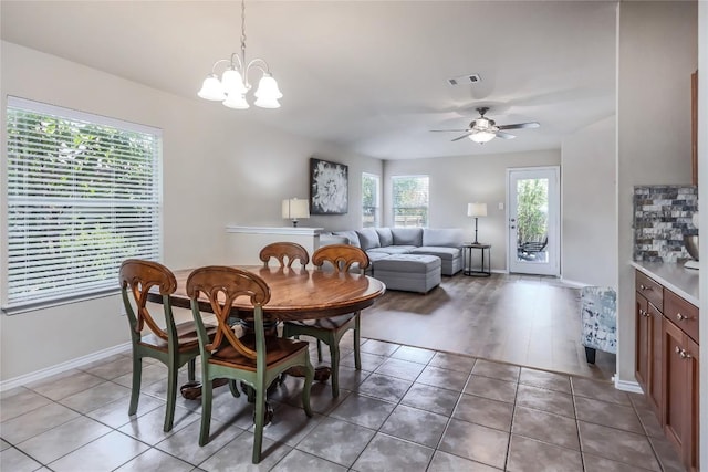 217 Baldwin St, Hutto, TX 78634 - dining area featuring baseboards, a ceiling fan, light tile patterned floors, and a chandelier