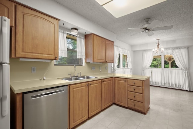 7104 Greenock St, Austin, TX 78749 - kitchen featuring stainless steel dishwasher, a sink, a peninsula, light countertops, and a textured ceiling