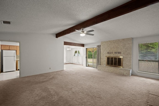 7104 Greenock St, Austin, TX 78749 - unfurnished living room featuring a ceiling fan, light carpet, healthy amount of natural light, a brick fireplace, and a textured ceiling
